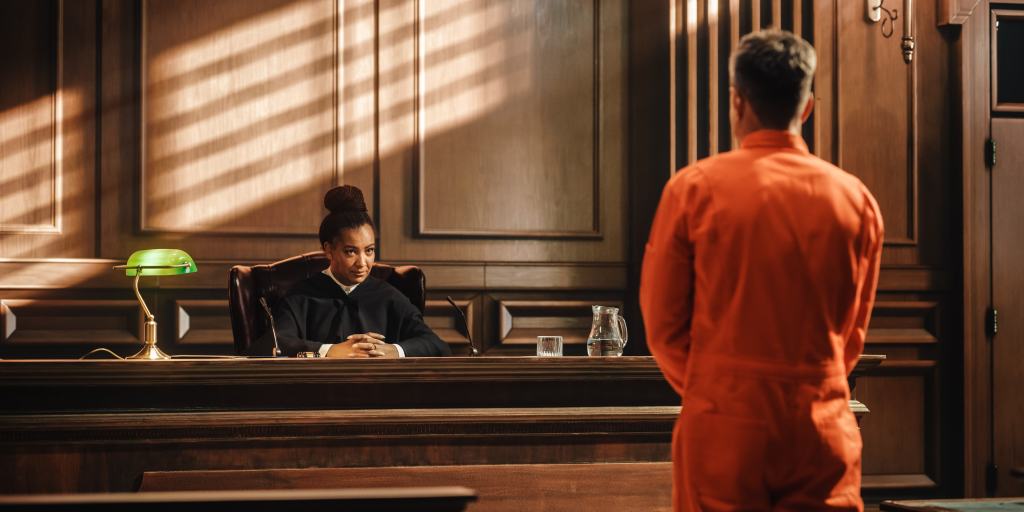 The judge and the defendant in his convict suit in a felony case trial.
