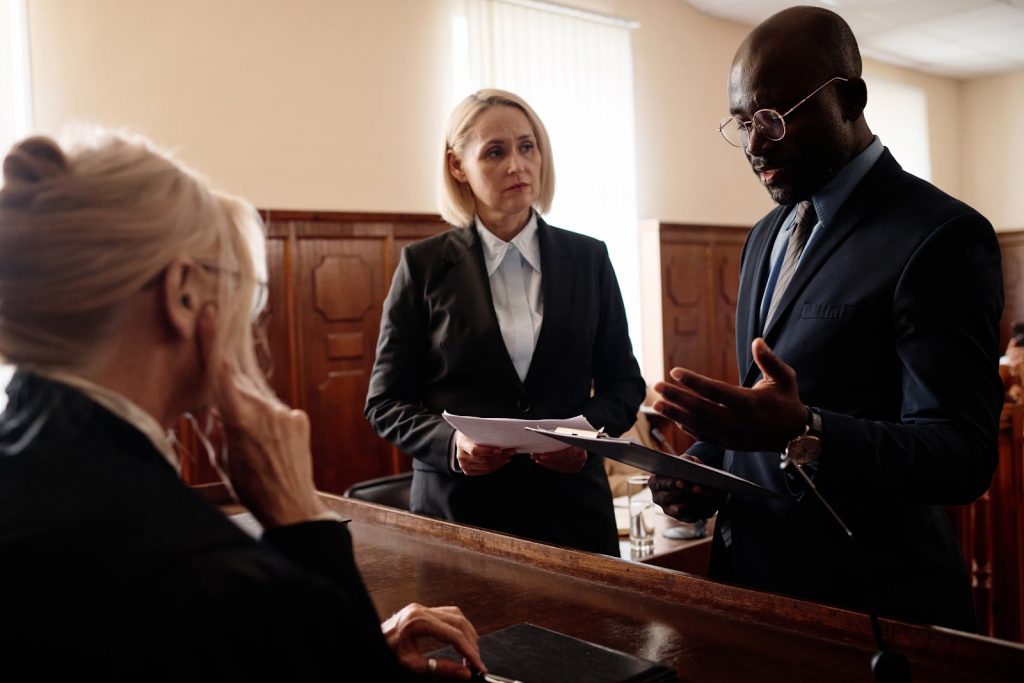 Two lawyers having a discussion with a judge