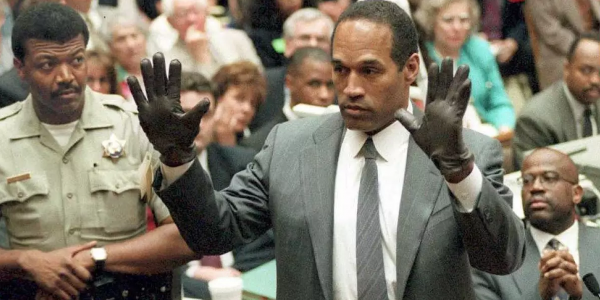 O.J Simpson tries the black leather gloves in court, which are found in the crime scene.