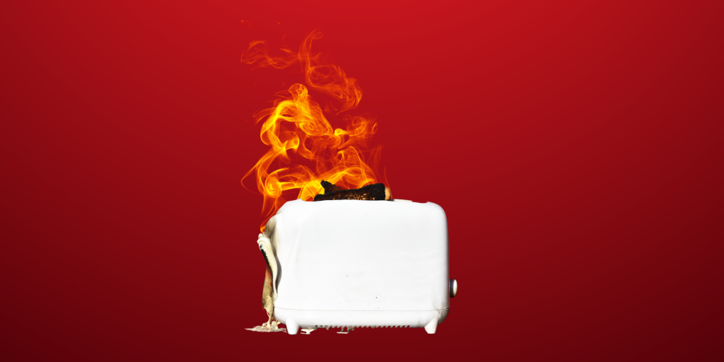 A burning white toaster representing product liability case timeline.